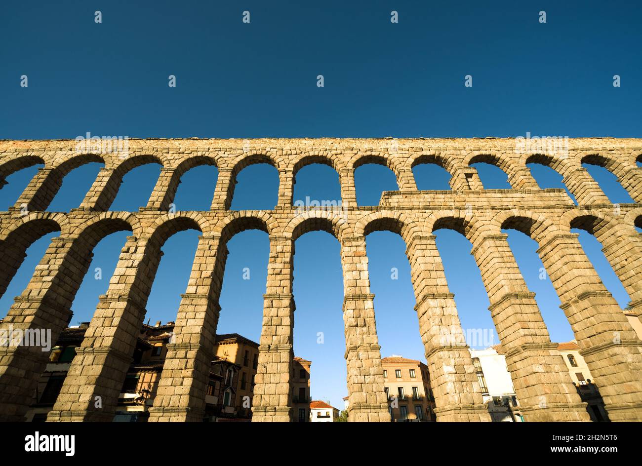 Roman aqueduct in Segovia, Spain. Low angle view Stock Photo