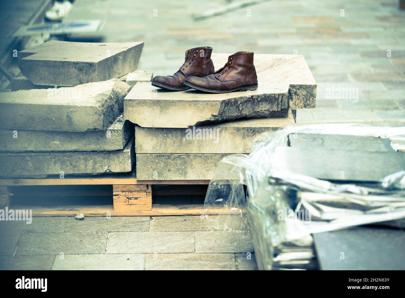 Pair of old boots left on the construction site Stock Photo Alamy