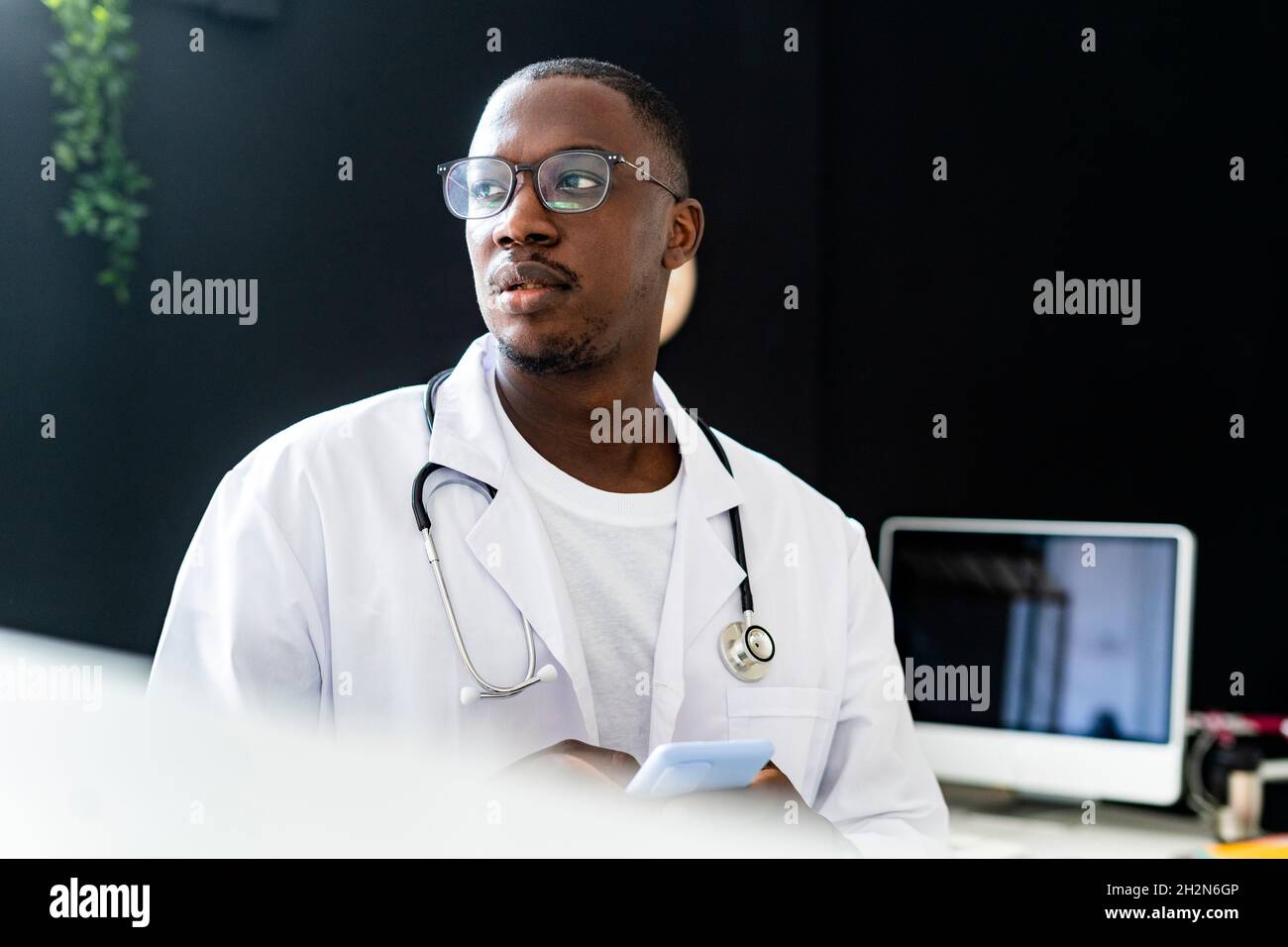 Male healthcare worker wearing eyeglasses at medical clinic Stock Photo