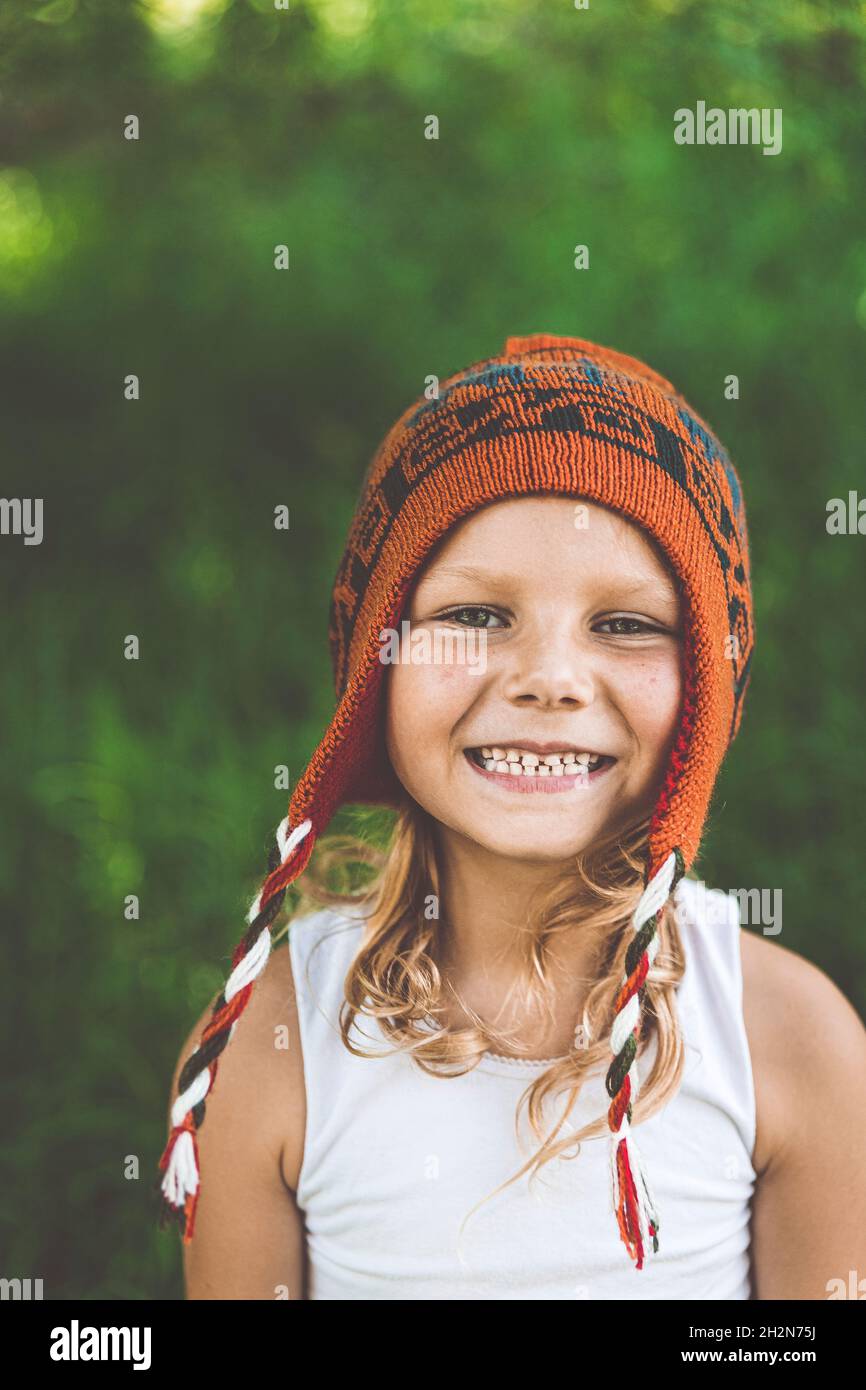 Happy girl wearing knit hat in summer Stock Photo