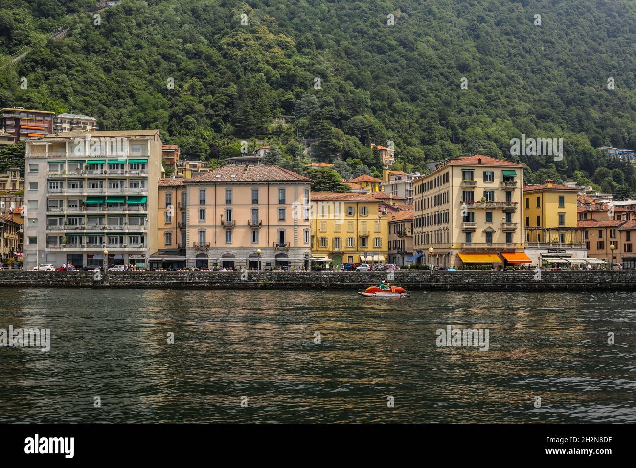 Como, Italy - June 15, 2017: View of Traditional Colorful Buildings by the Lake on a Cloudy Day Stock Photo