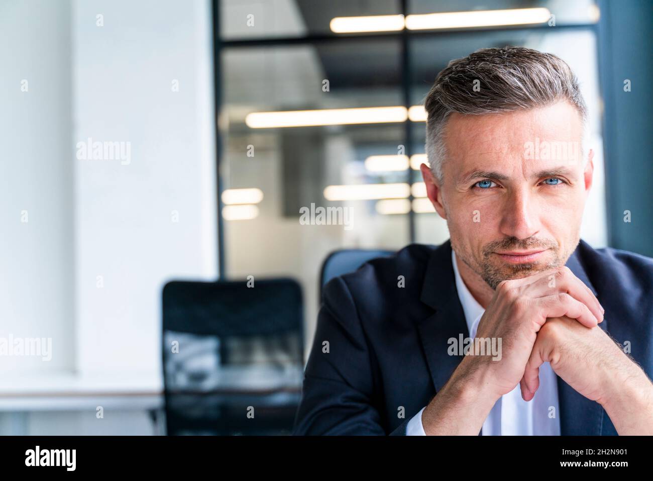 Mature businessman sitting hand hi-res stock photography and images - Alamy