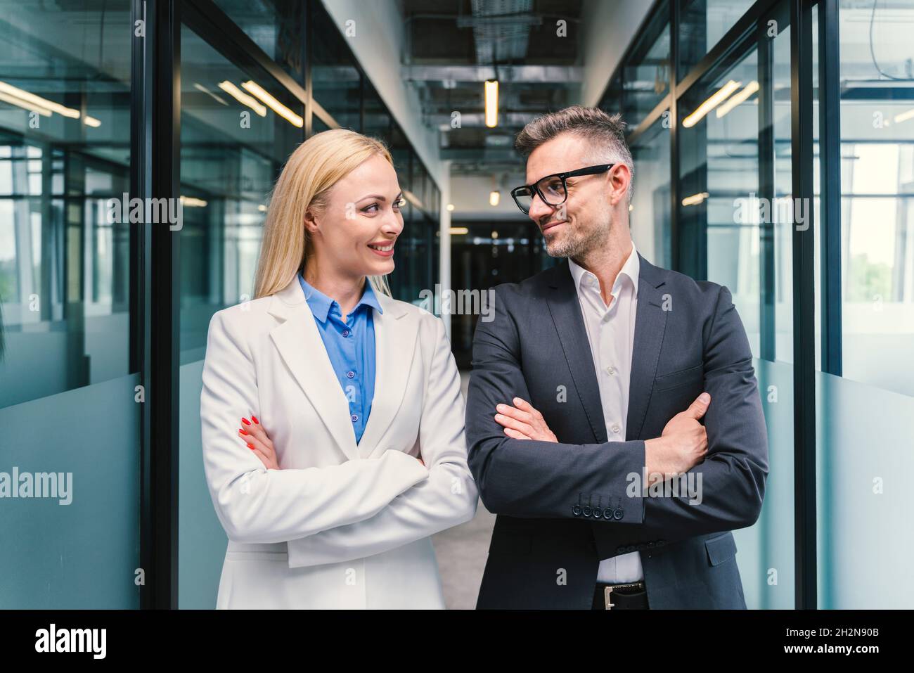 Smiling male and female business professionals looking at each other in office Stock Photo