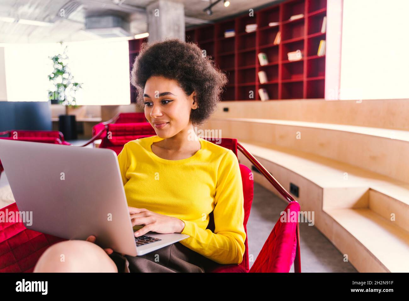 Young businesswoman using laptop in office Stock Photo