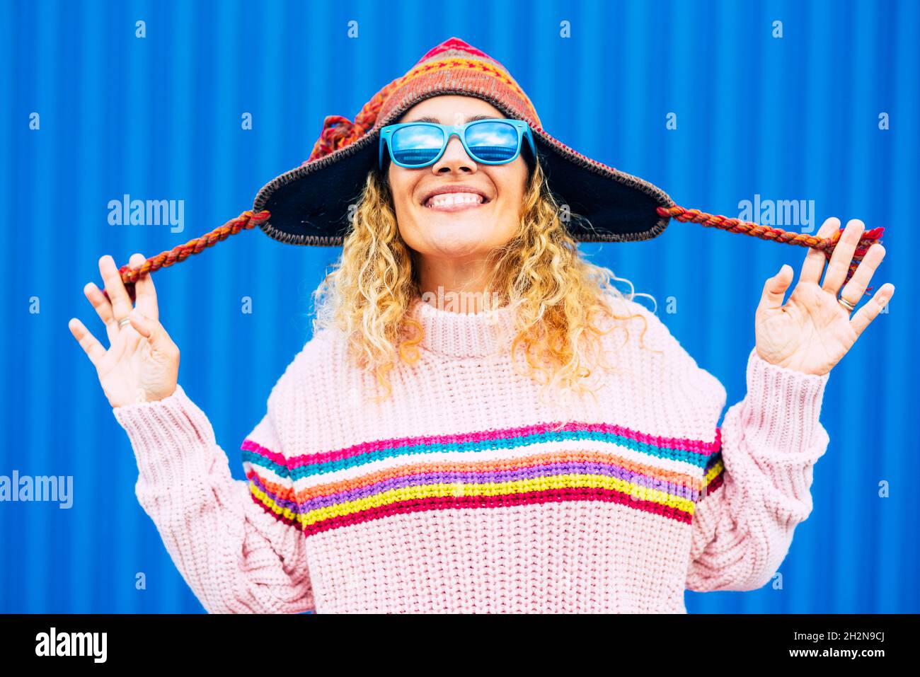 Cheerful mature woman wearing knit hat and sunglasses Stock Photo