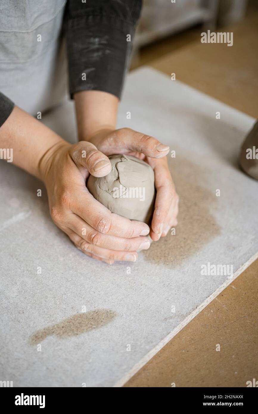 Female craft expert molding clay on workbench Stock Photo Alamy