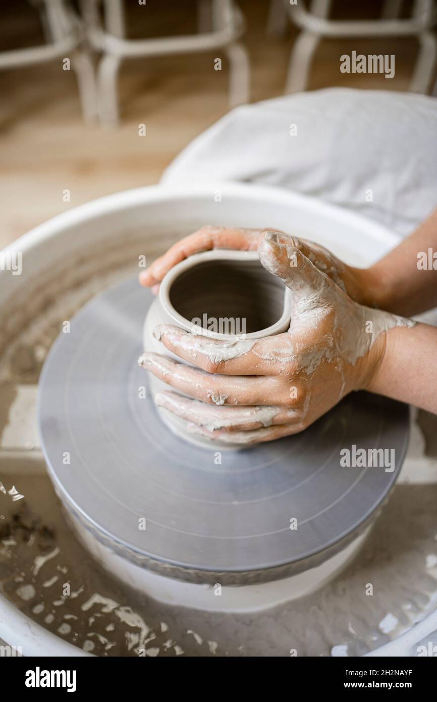 Young female potter molding clay on pottery wheel Stock Photo Alamy