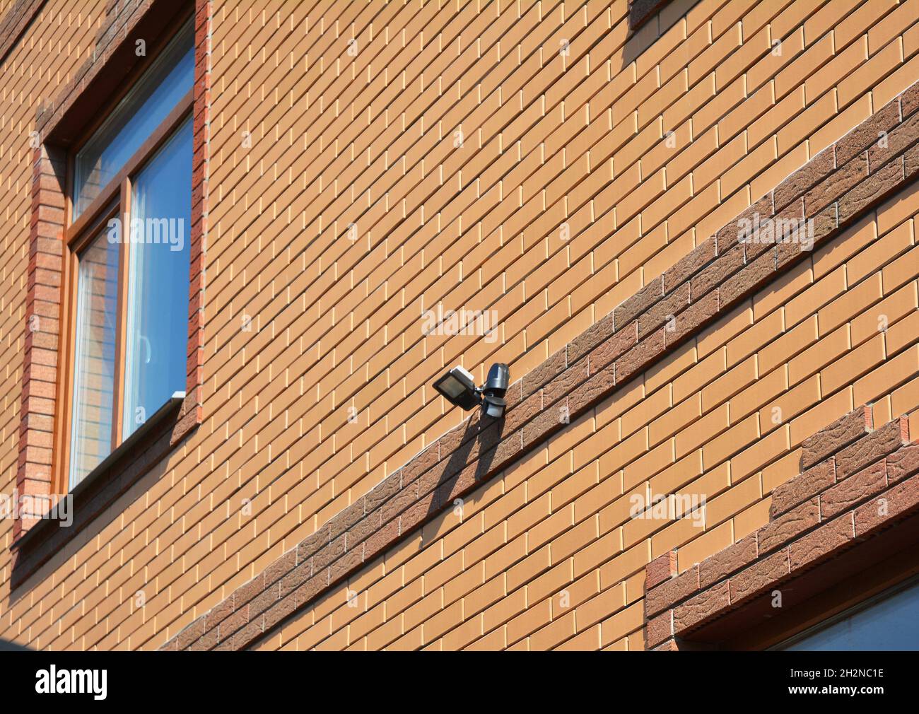 Motion Flood LED Light on House Brick Wall Outdoor. How to Choose and