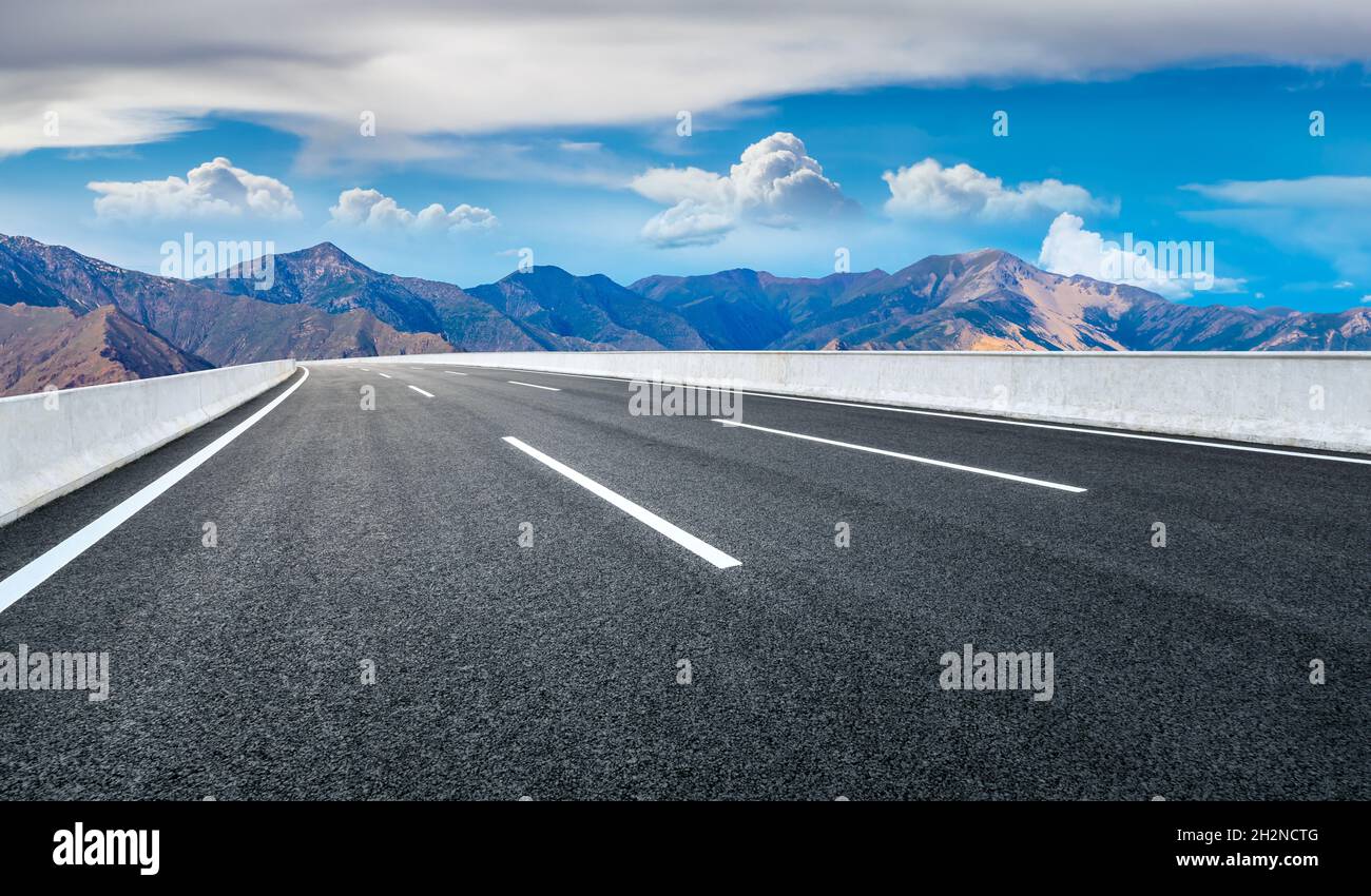 Asphalt road and mountain with sky clouds landscape Stock Photo - Alamy