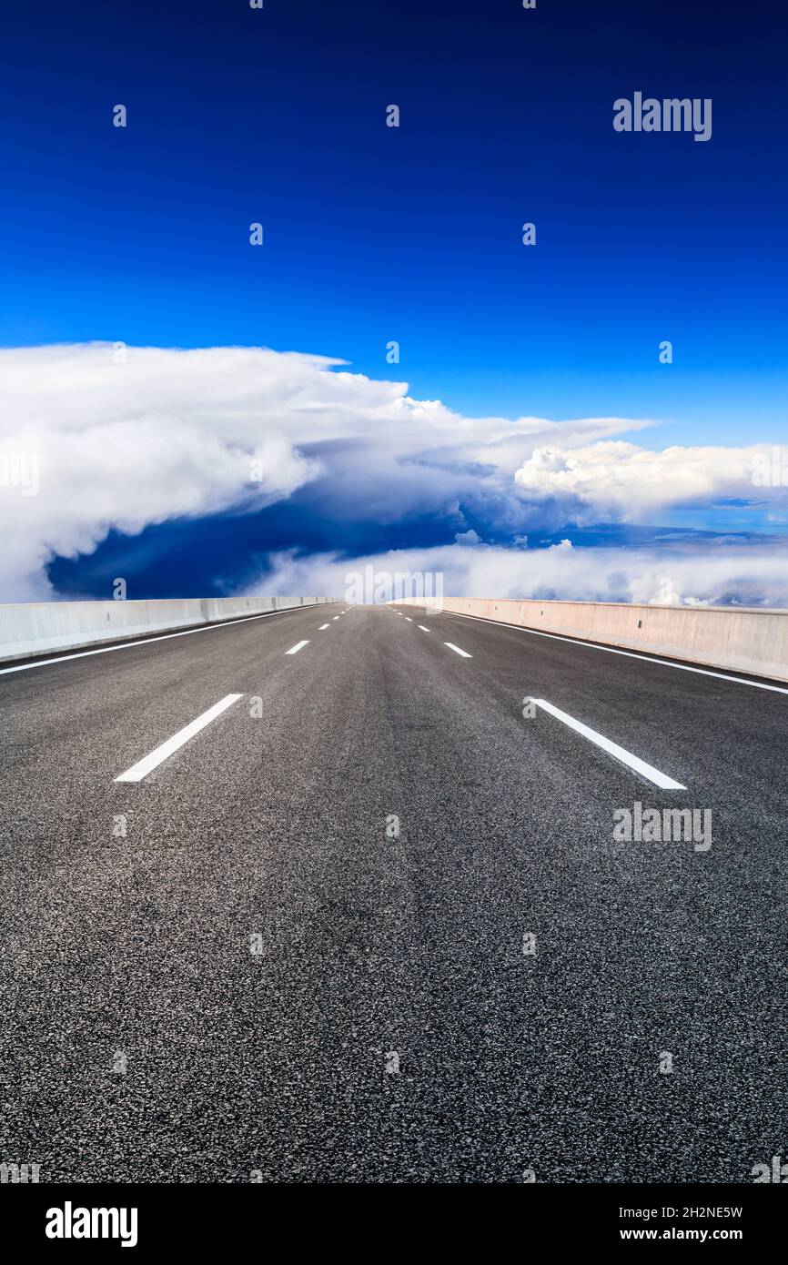 Empty asphalt road and blue sky with white clouds scenery Stock Photo ...
