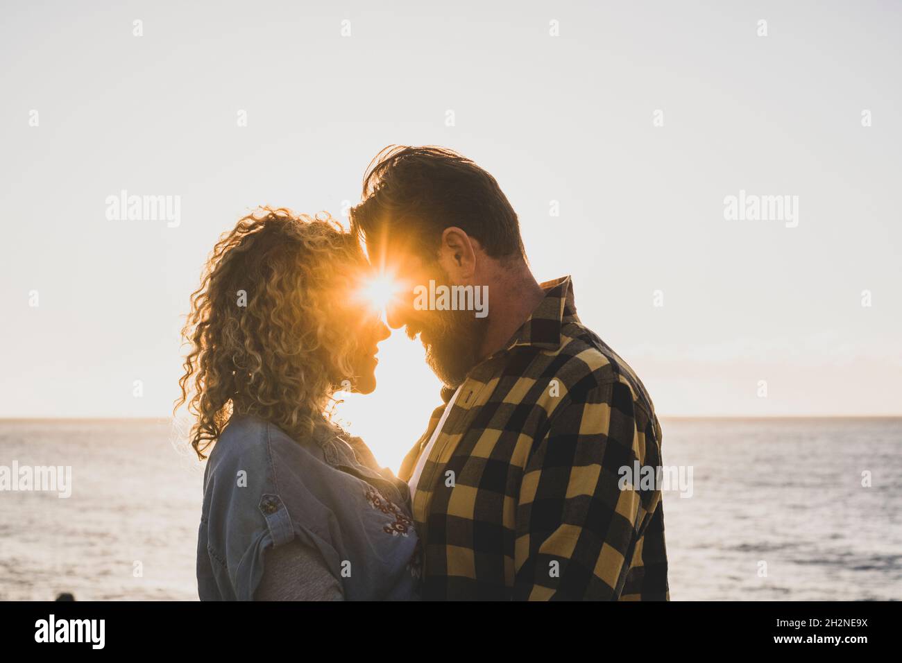 Bearded man romancing with girlfriend at beach Stock Photo