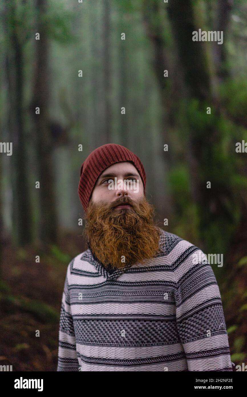 Bearded man with knit hat in forest Stock Photo