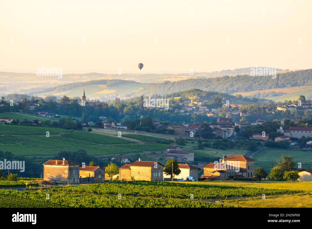 Baloon flying over Le Bois d'Oingt village, Beaujolais Stock Photo