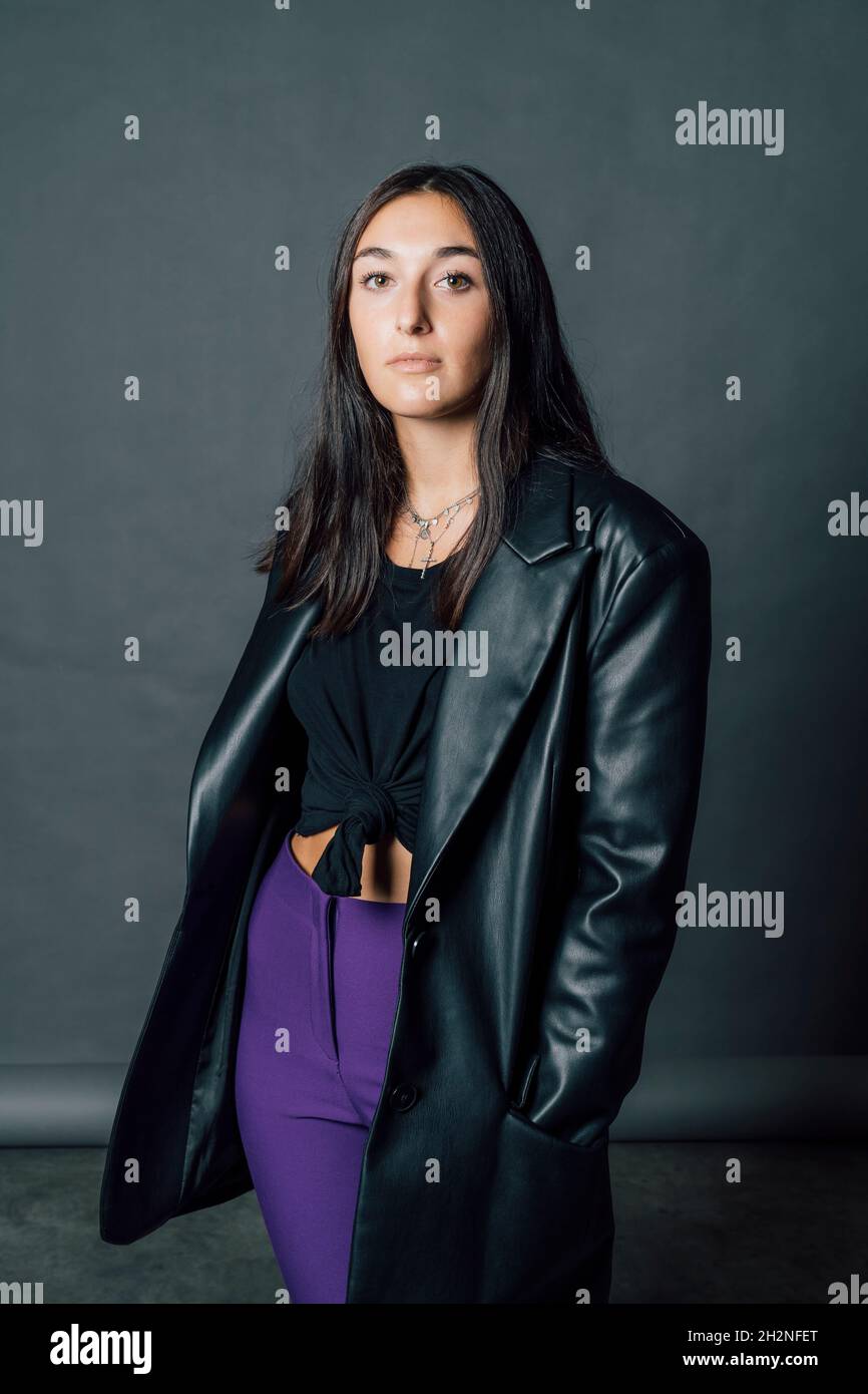 Young woman wearing black leather jacket in studio Stock Photo - Alamy
