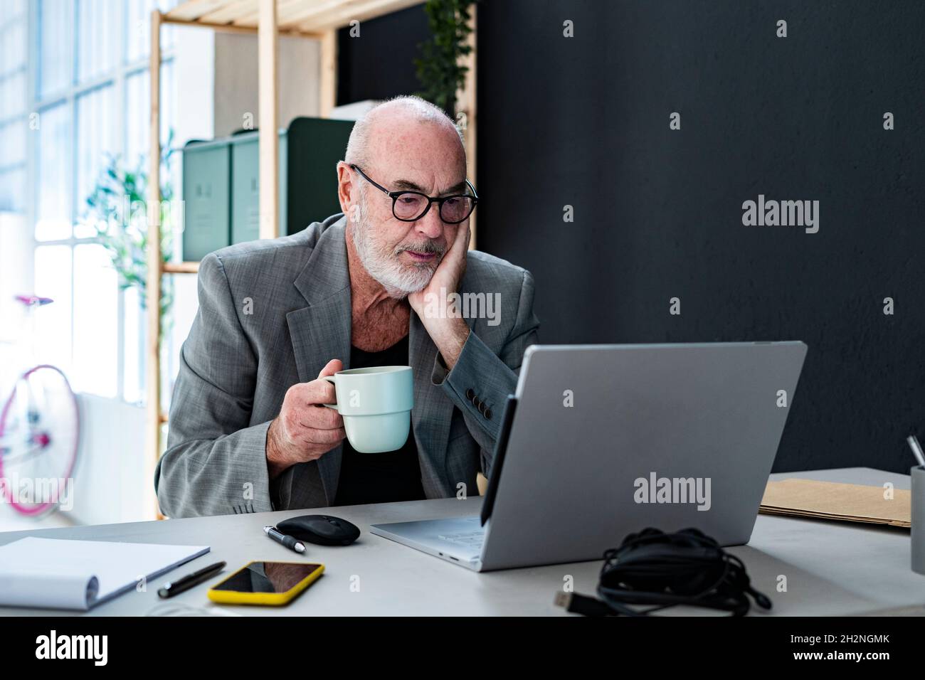 Male professional reading documents in studio Stock Photo