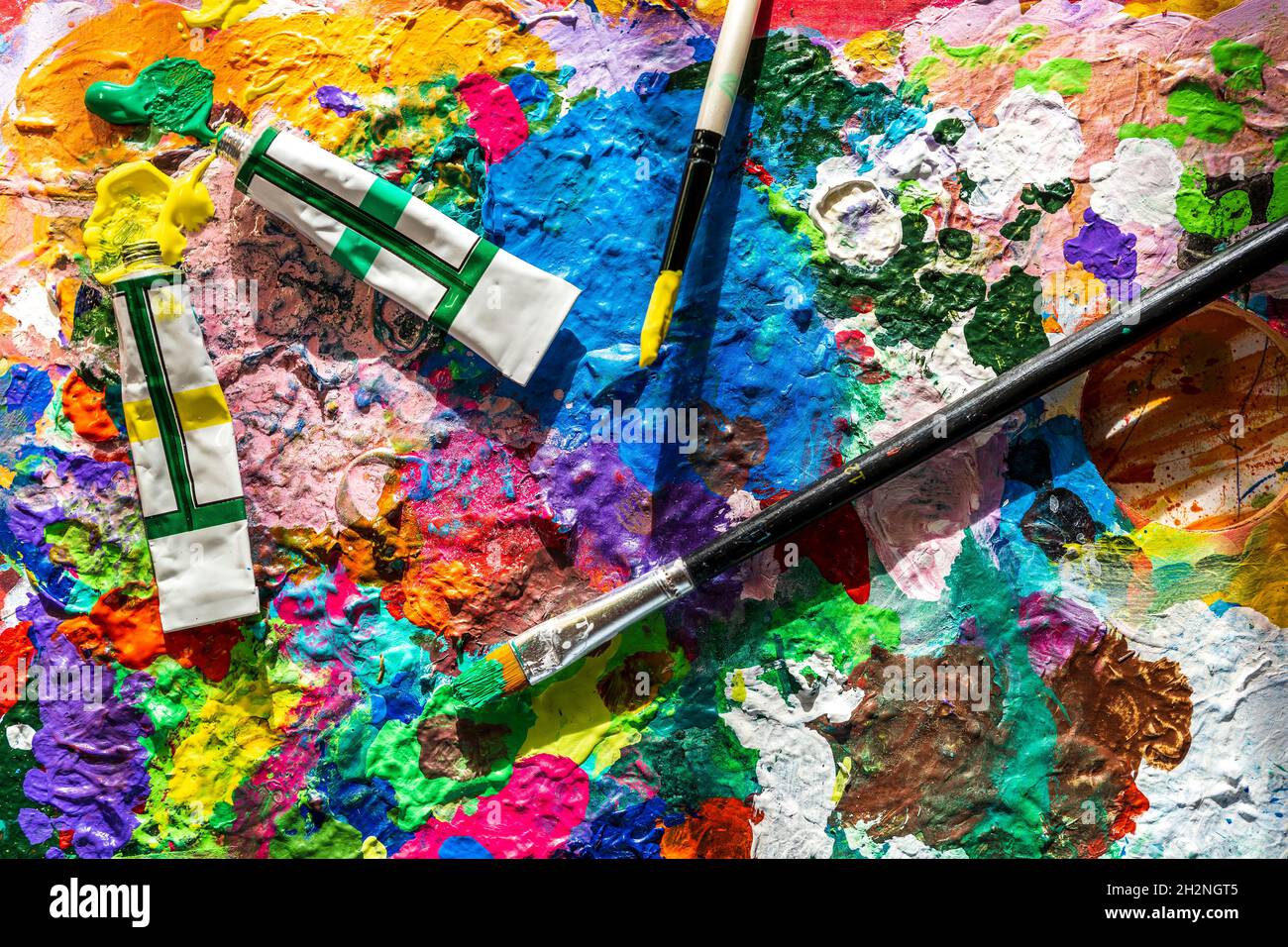 Art brushes, oil paint tubes, artist palette on wooden table Stock Photo by  ©ChamilleWhite 19857057