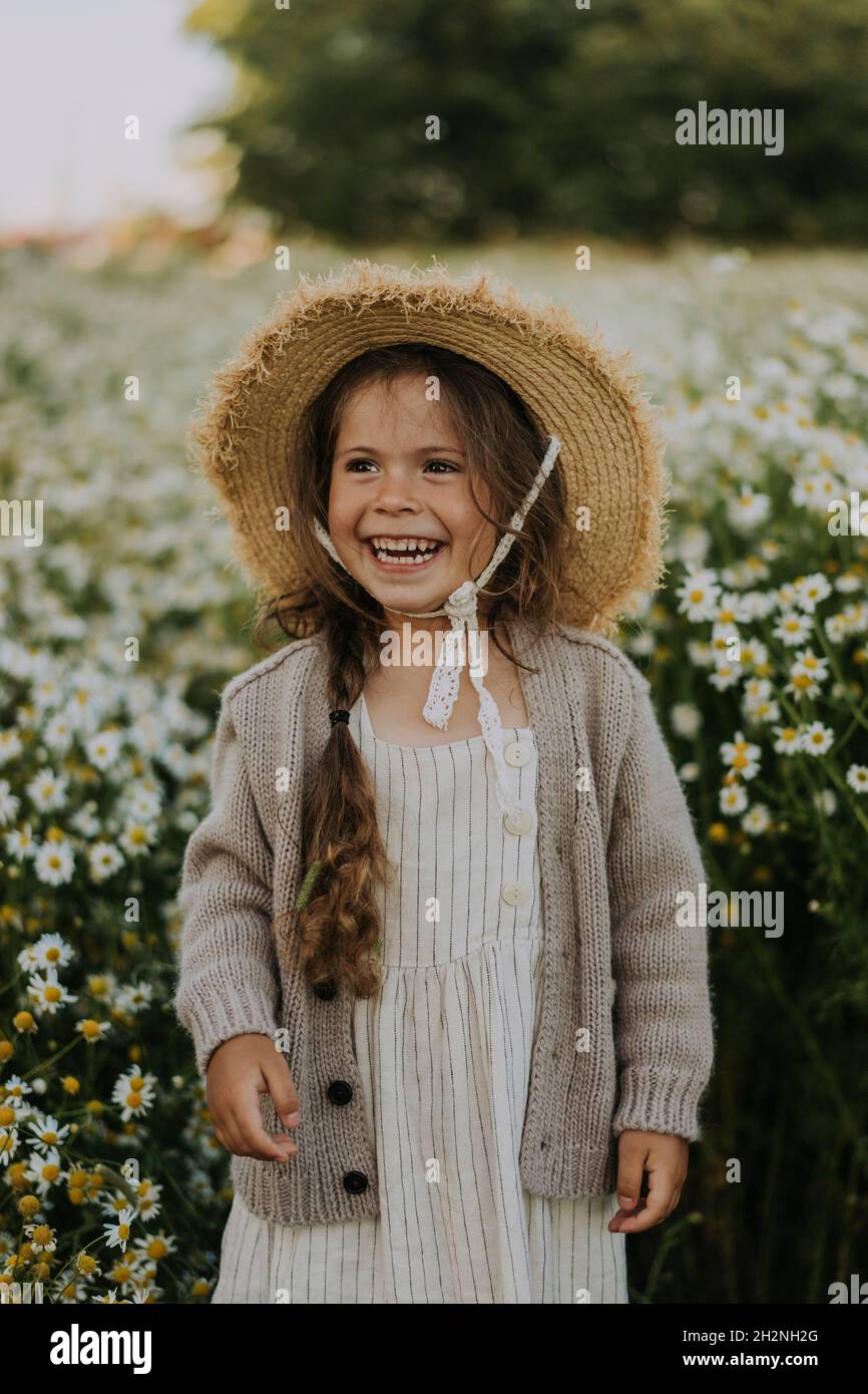 Girl standing in flower field hi-res stock photography and images - Alamy