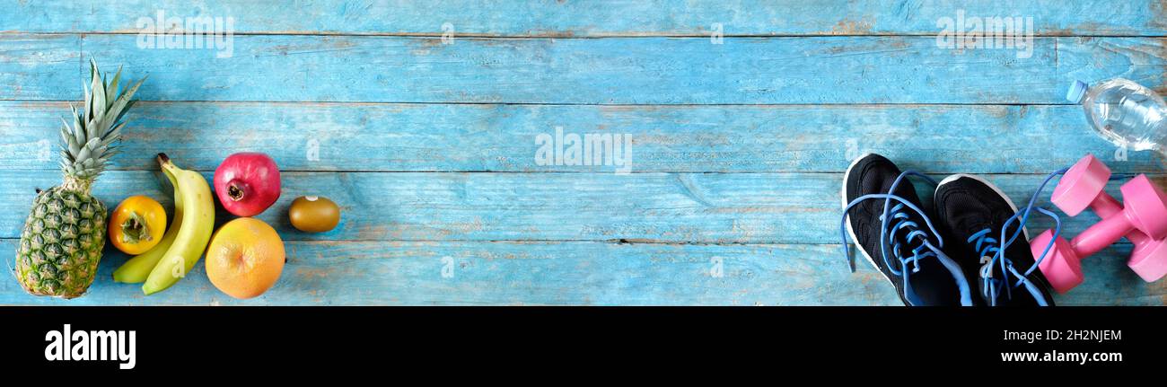 Various fruit,pair of runners and dumbells.Sport,fitness,healthy lifestyle concept, flat lay, large copy space Stock Photo