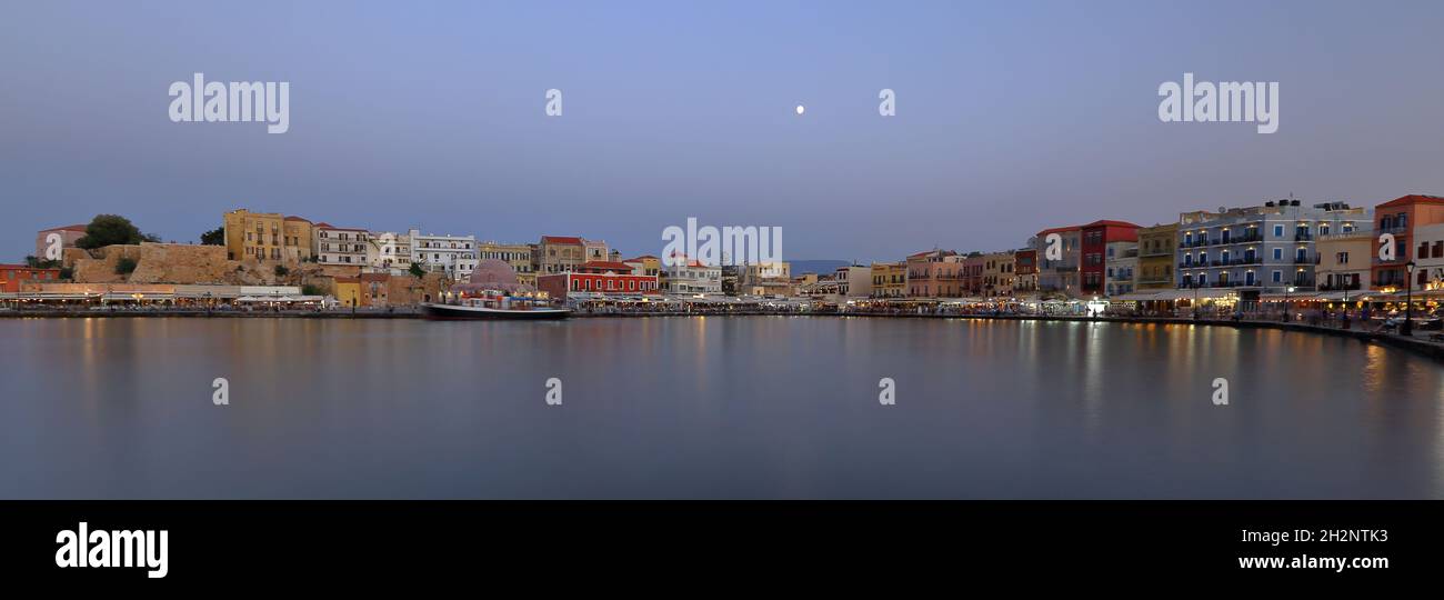 Panoramic view of Chania, Crete, Greece, Mediterranean sea bay and shore with local architecture, reflections in water Stock Photo