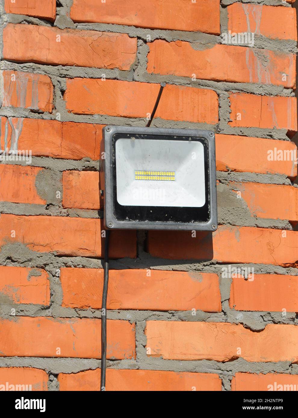 LED flood light, spot light on the top house construction site outdoor. Waterproof LED