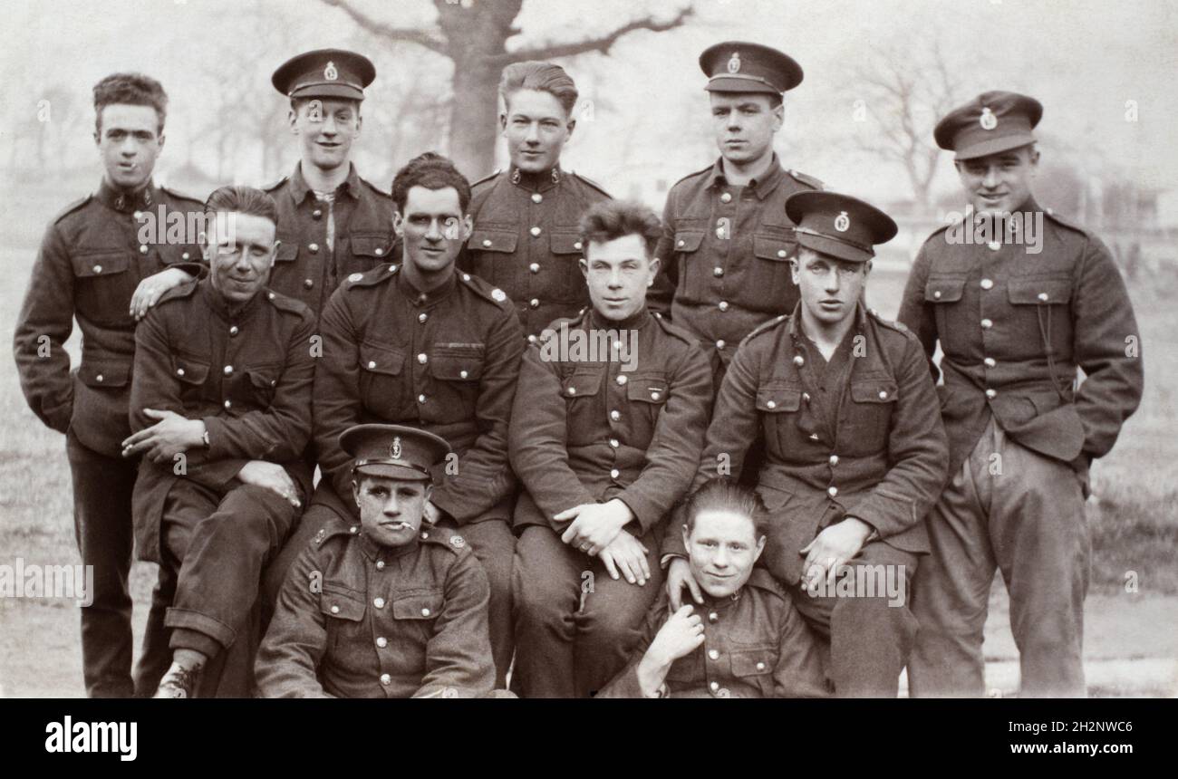 An inter-war era group potrait of British soldiers, signalers in the Royal Corps of Signals, c.1920s. A few of the soldiers have Good Conduct Stripes on their lower left arm. The middle solider, second from the left has four stripes, indicating at least 16 years service. This mans greater experiance over the others is further shown by his medal ribbons. Stock Photo