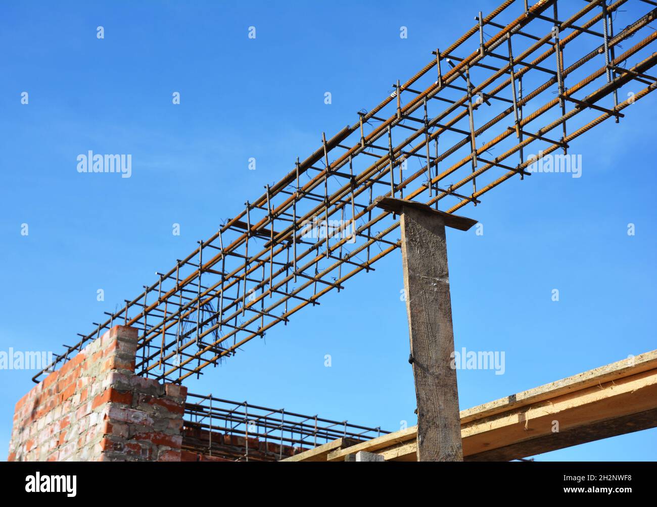 Lintel Construction. Rebar steel bars on new home construction corner, reinforcement concrete bars with wire rod as a lintel for window. Stock Photo