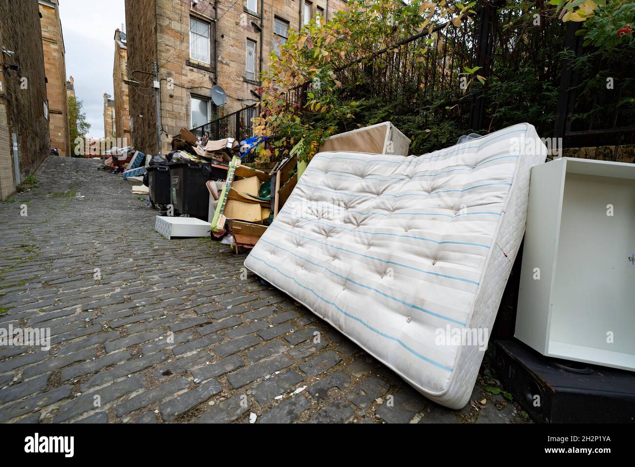 Glasgow, Scotland, UK. 23rd October 2021. Domestic waste is seen discarded in the streets of Govanhill in Glasgow with one week to the start of the UN Climate Change Conference COP26 in the city. City refuse collectors have said they will strike during the conference leading to fears that the city streets will be full of rubbish while in the world’s spotlight.  Iain Masterton/Alamy Live News. Stock Photo