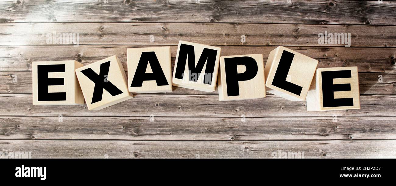 example word written on wood block. examples text on table, concept ...