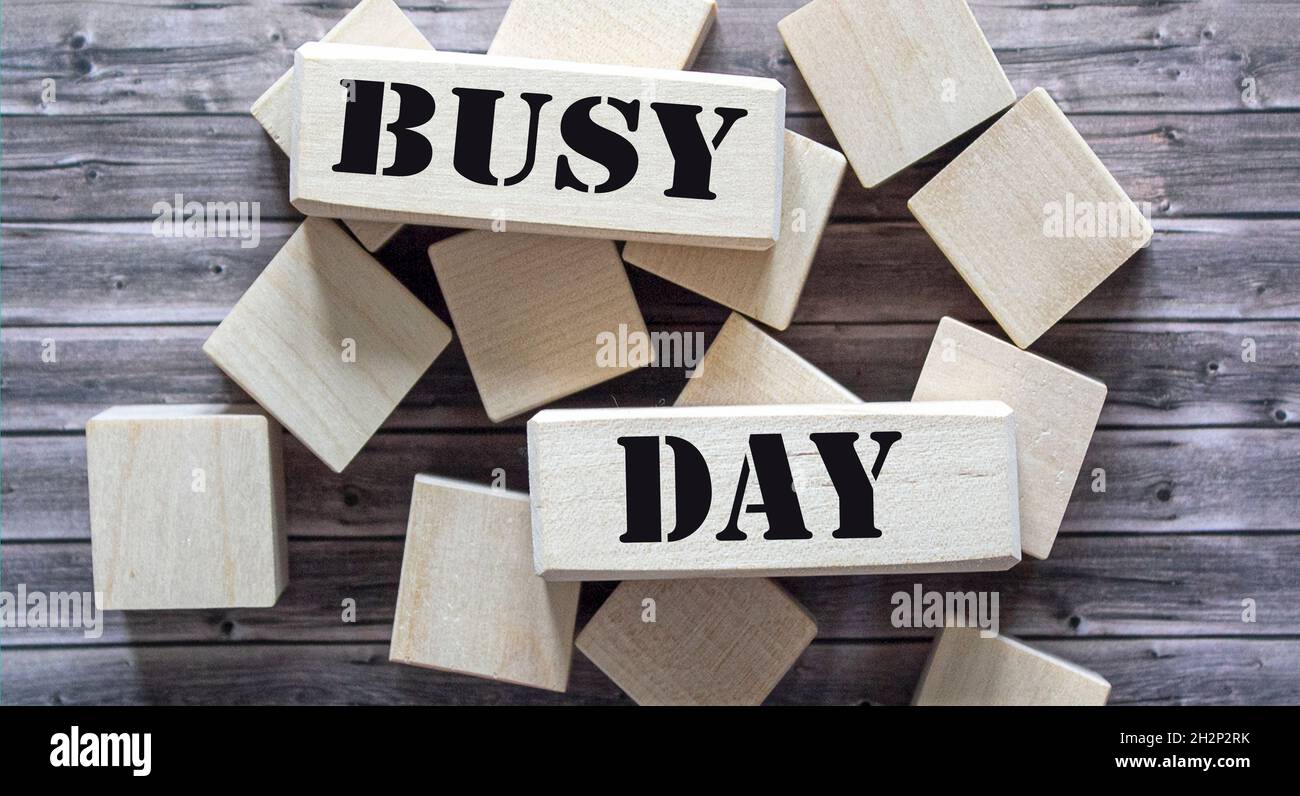text on busy day blocks and wooden background Stock Photo