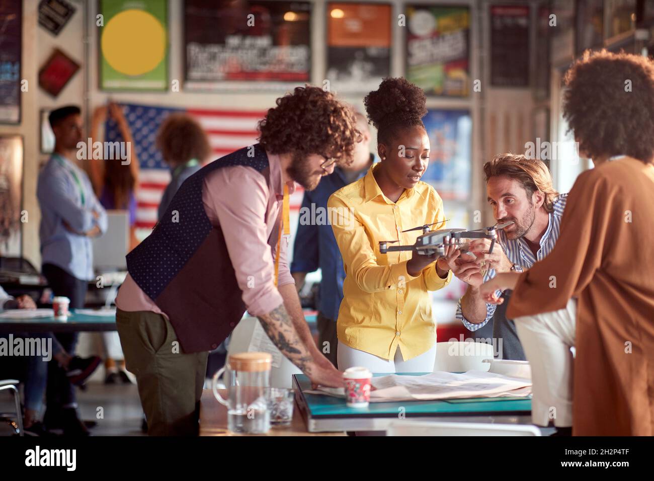 Group of young coworkers projecting the drone together Stock Photo - Alamy