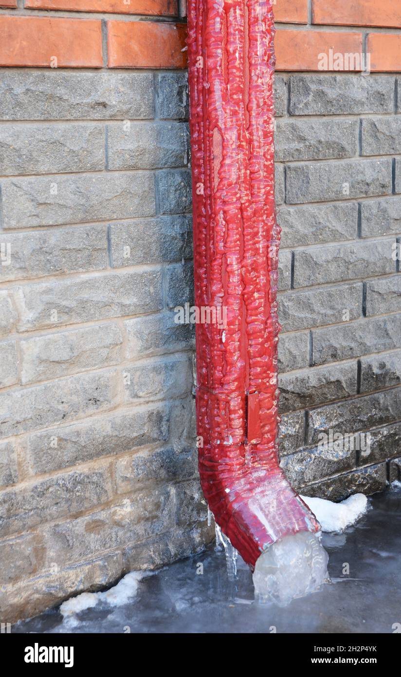 Frozen Rain Water Draining Gutter Down pipe. Downspout Ice dams. Rain