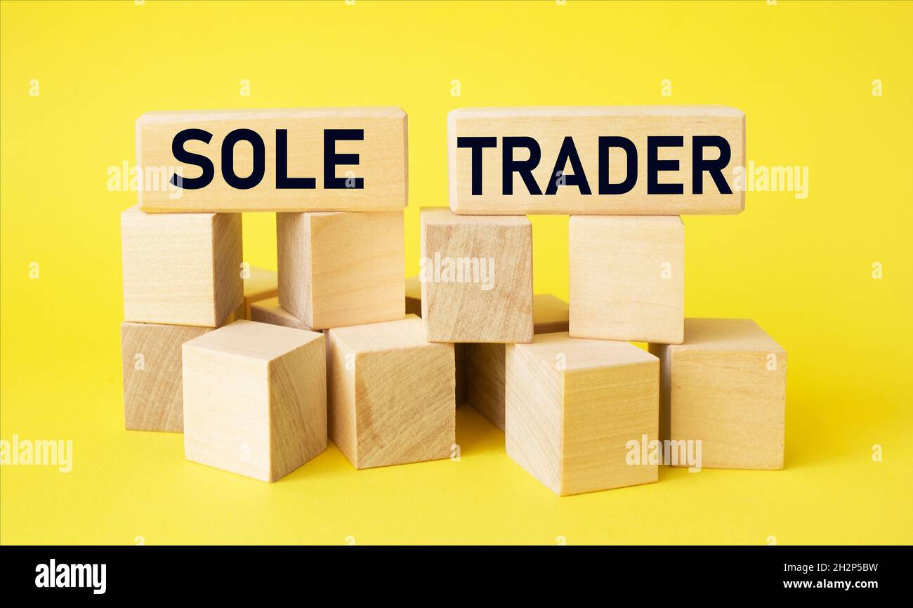 Sole trader on wooden blocks and yellow background. Business concept Stock Photo
