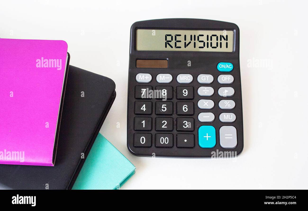Revision, text on the calculator. Colored notepads on white background Stock Photo