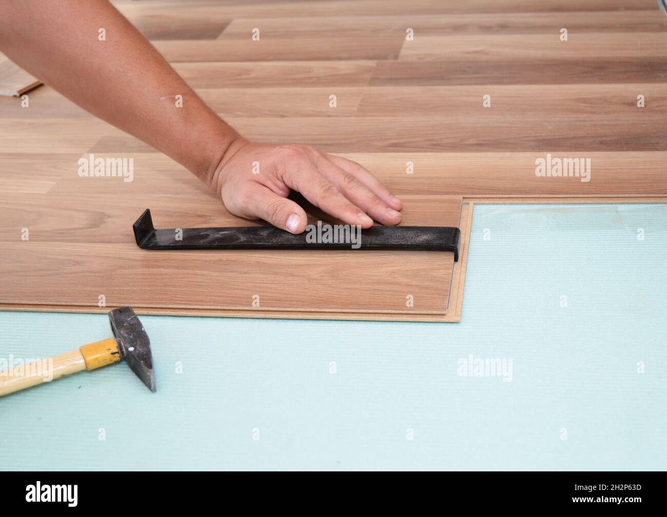 Installing laminate flooring. Man Installing New Laminate Wood Flooring