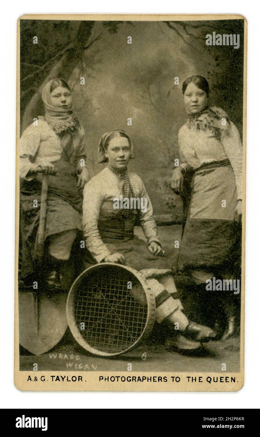 Original Victorian CDV of 3 Wigan (Lancashire) pit brow girls, wearing working clothes, including trousers with shovels and sieves, working tool tools. Photo by Wragg of Wigan (printed on front of photograph)  & reproduced by A. & G. Taylor, 34 Church St. Liverpool, U.K. circa 1885 Stock Photo