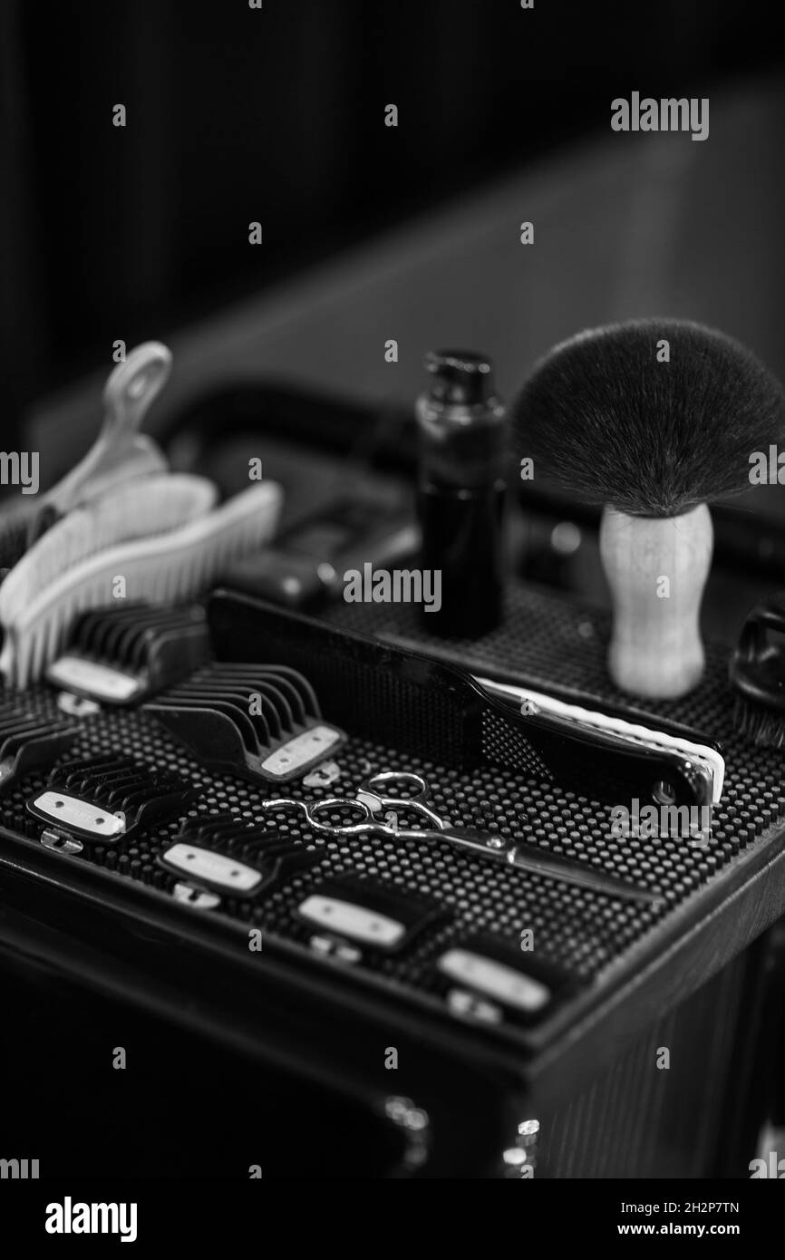 Barber shaving kit and brush lying in box. Set of professional hairdresser tools Concept of hygiene beauty and haircare. Stock Photo