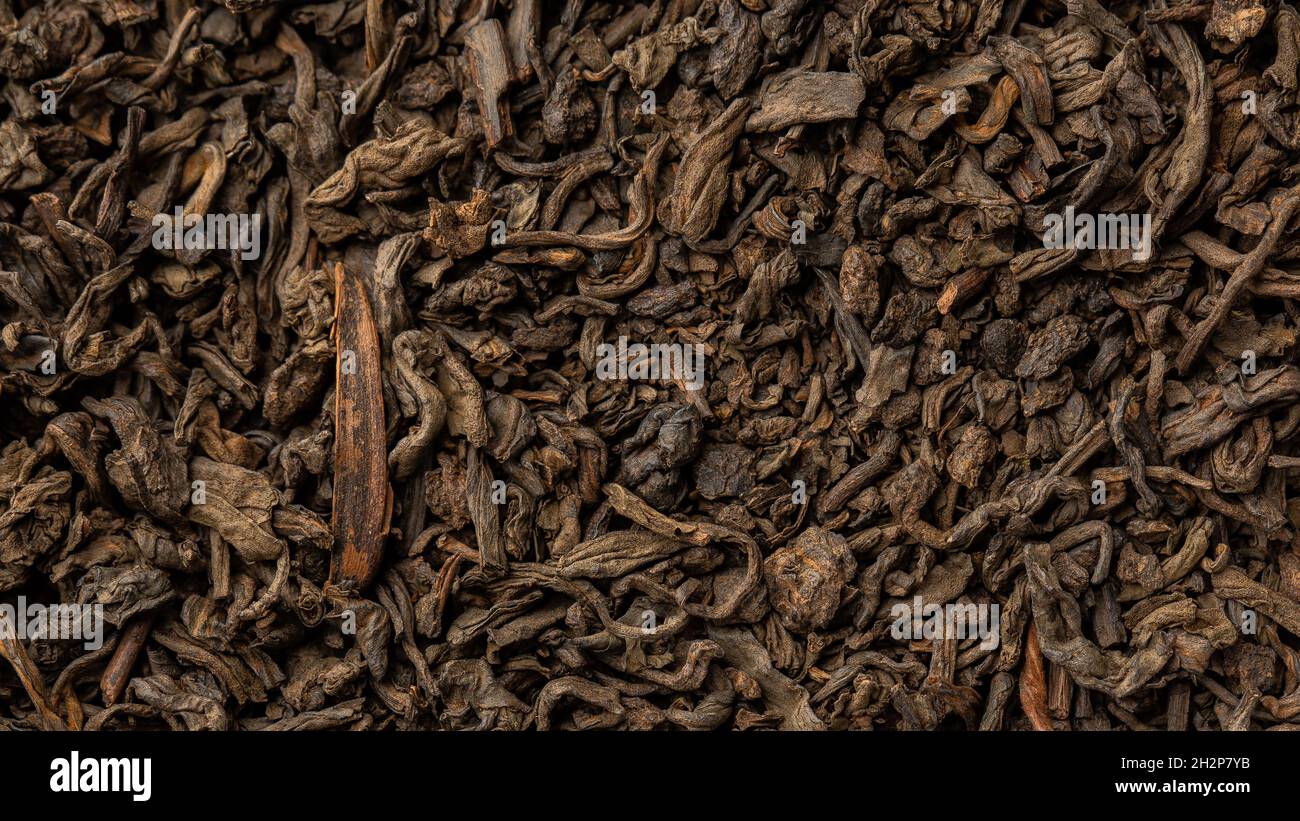 Heap of dry tea leaves. Dried black tea. Textured background of dried
