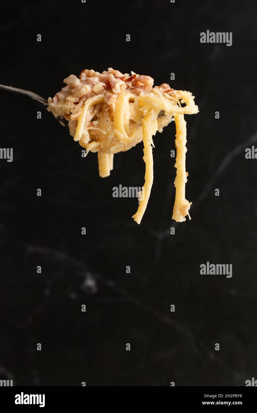 pasta-carbonara-on-fork-isolated-spaghetti-with-bacon-parmesan-cream