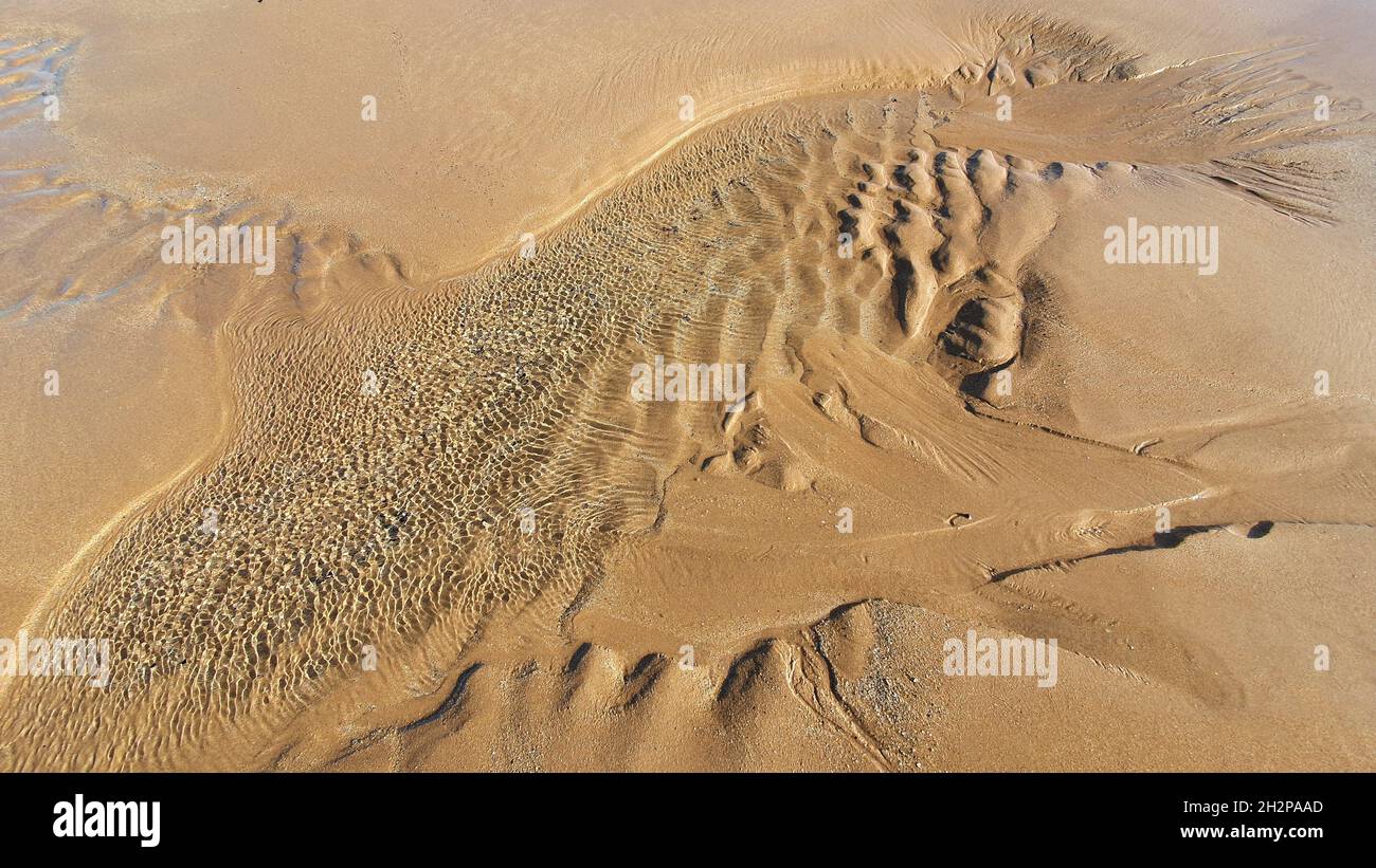 Pattern and textures in sand Stock Photo - Alamy