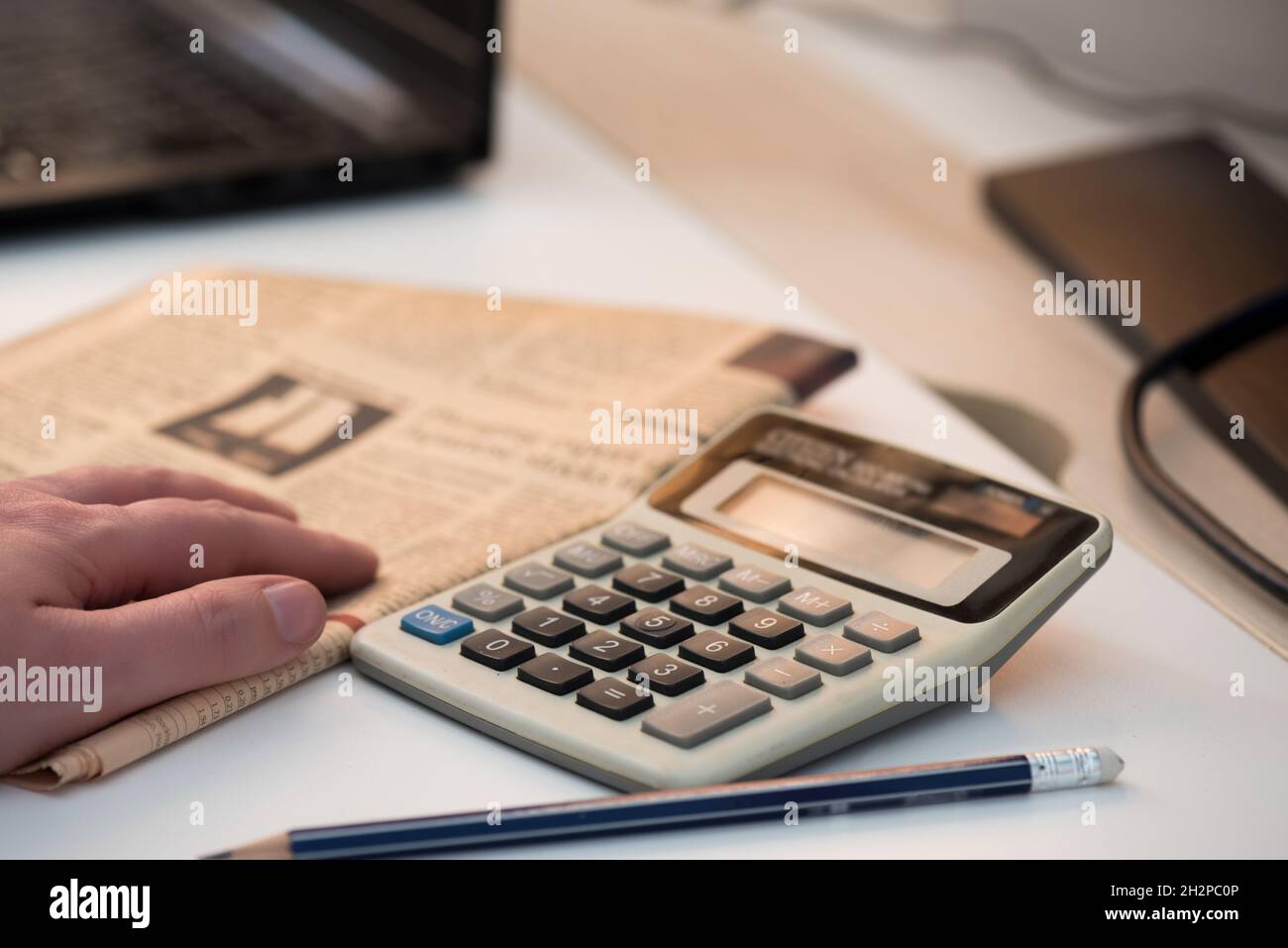 Calculator and finance newspaper. Coronavirus concept. Work from home concept Stock Photo