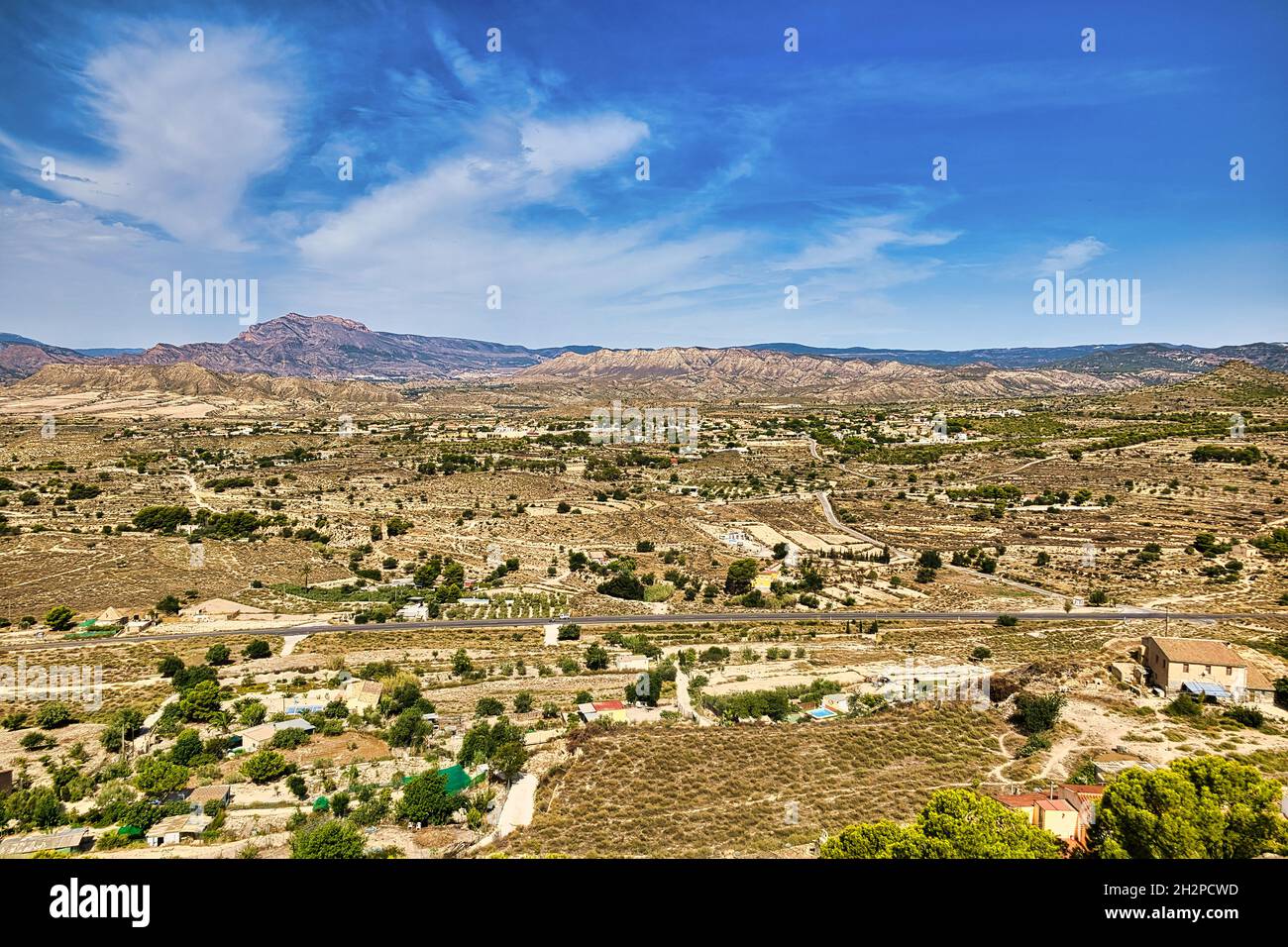 View from the hill to the Busot area and the Cabeco D'or mountain range. Beautiful sunny landscape with a blue sky.Horizontal view Stock Photo