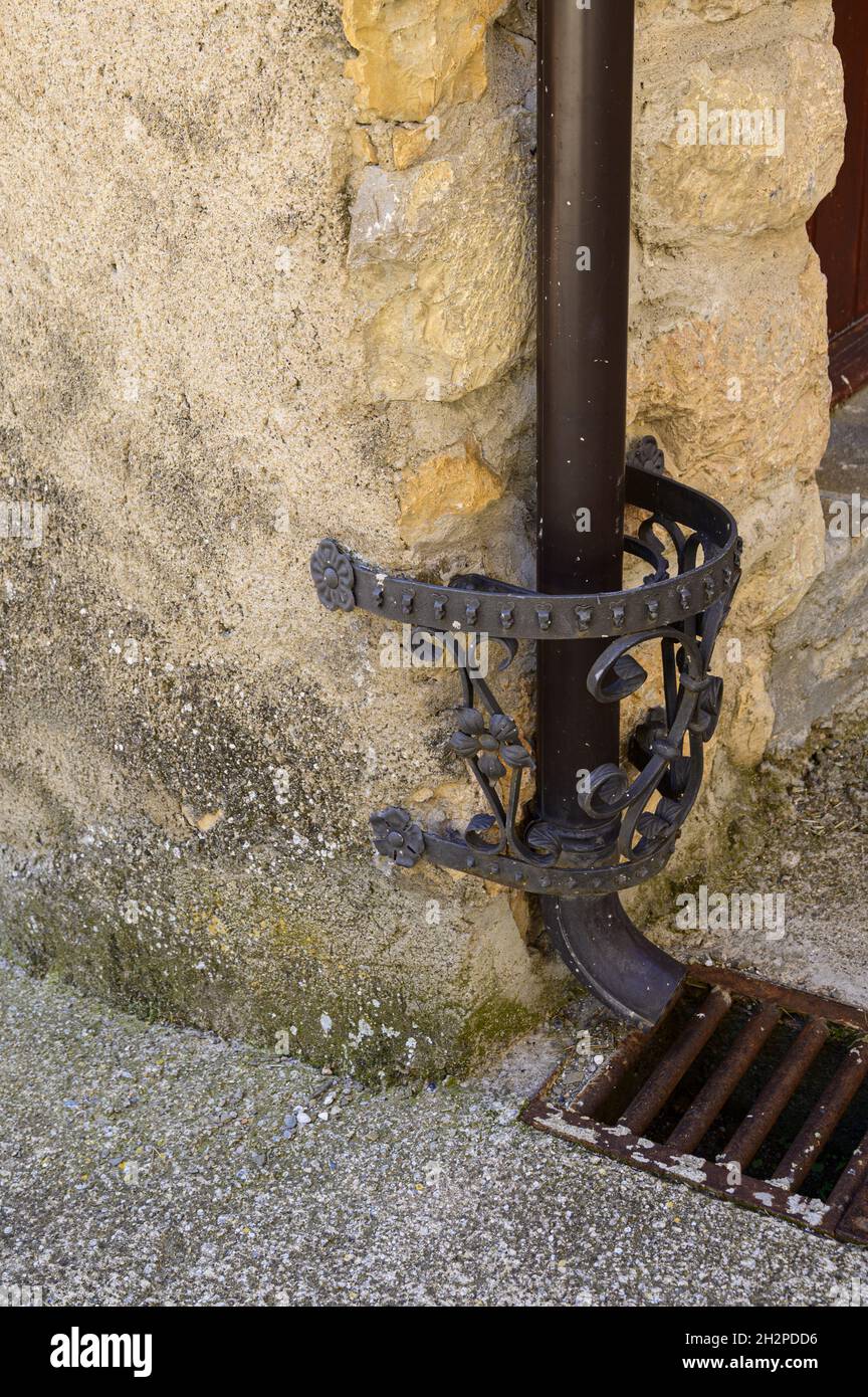 Vertical shot of an old cast iron pipe holder on a wall Stock Photo Alamy