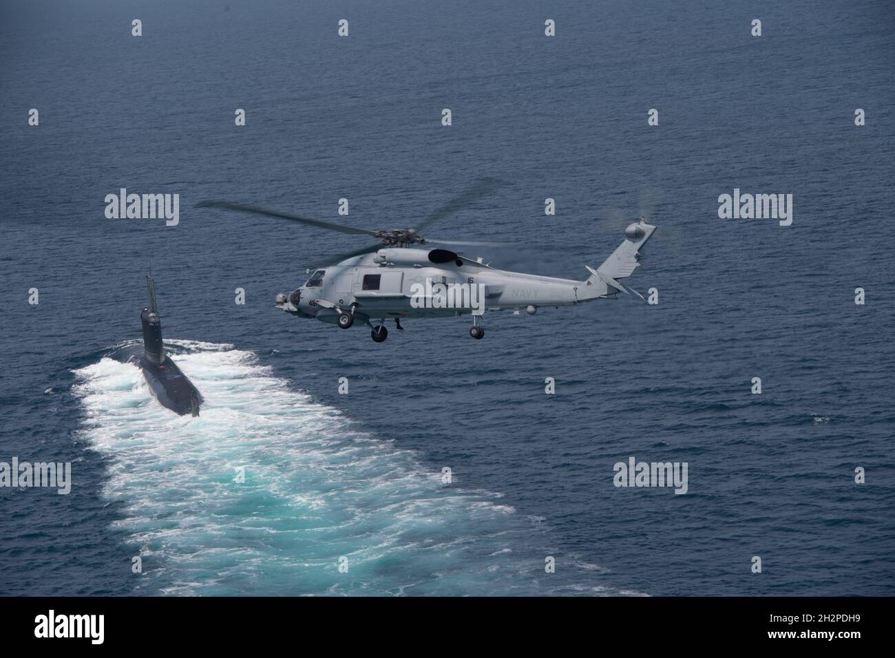 San Diego, United States. 16 August, 2021. A U.S. Navy MH-60R Seahawk helicopter flies over a Chilean Navy Scorpene Class Submarine CS Carrera during Diesel-Electric Submarine multi-national Initiative Hoist Exercise 2021 August 16, 2021 near San Diego, California.  Credit: MC2 Sara Eshleman/U.S. Navy/Alamy Live News Stock Photo