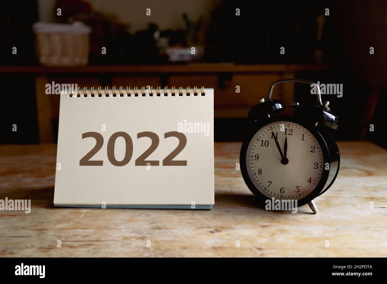 2022 calendar and black vintage clock on wooden table Stock Photo