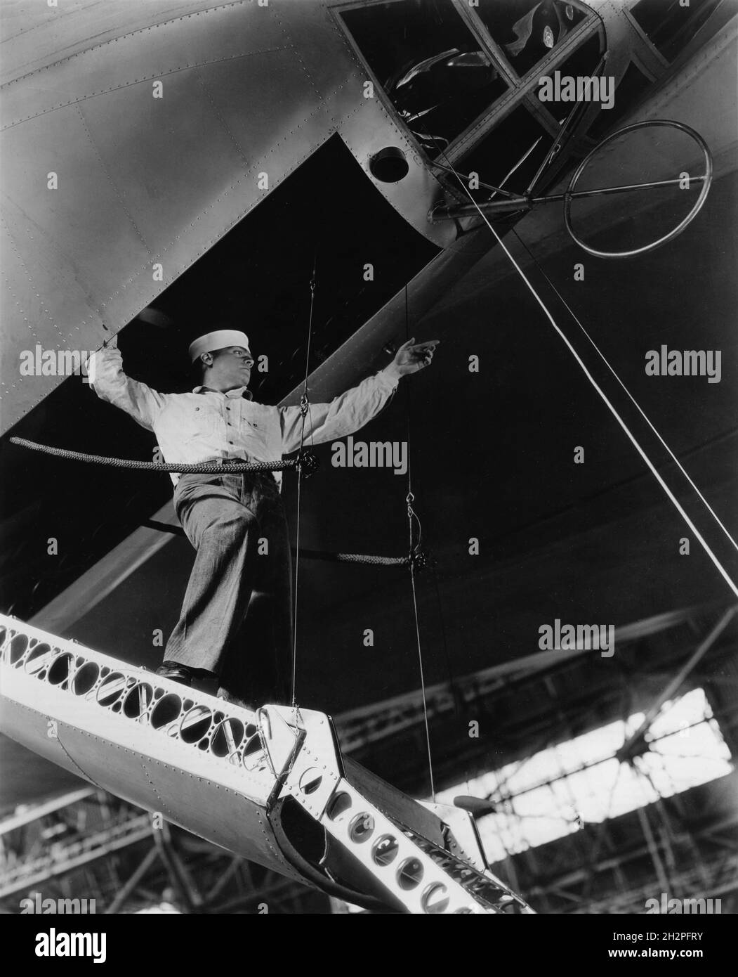 JAMES CAGNEY on set location candid inspecting aircraft during filming of DEVIL DOGS OF THE AIR 1935 director LLOYD BACON based on story by John Monk Saunders costume design Orry-Kelly A Cosmopolitan Production / Warner Bros. Stock Photo