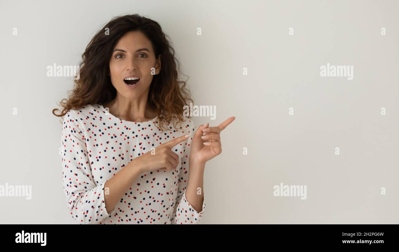 Surprised excited female customer, shopper advertising sale Stock Photo