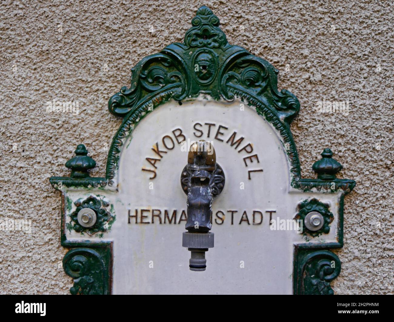 Stylish vintage water fountain in patio of old house, Sibiu, Romania. High quality photo Stock Photo