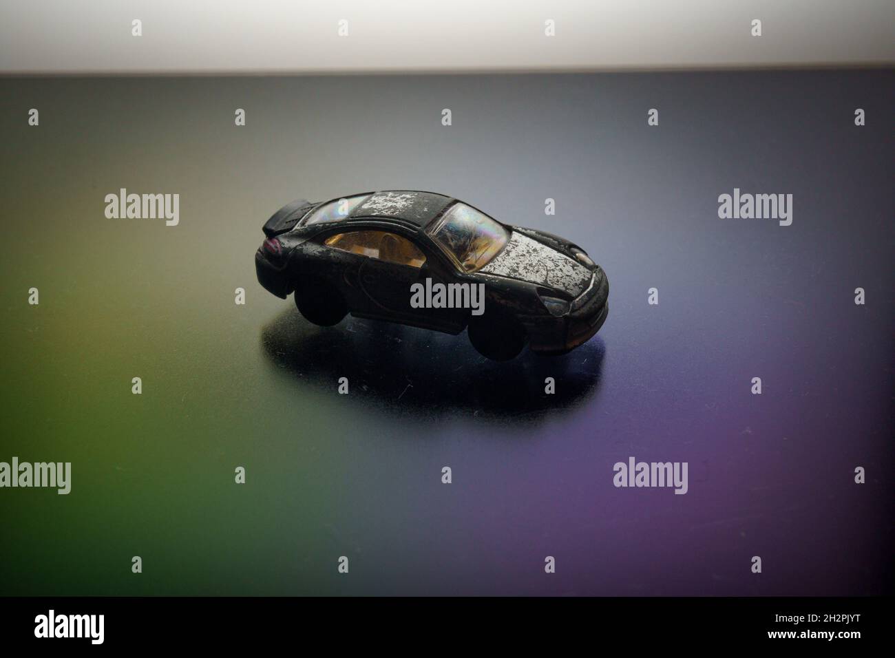 old retro scratched model toy sports car on the background Stock Photo