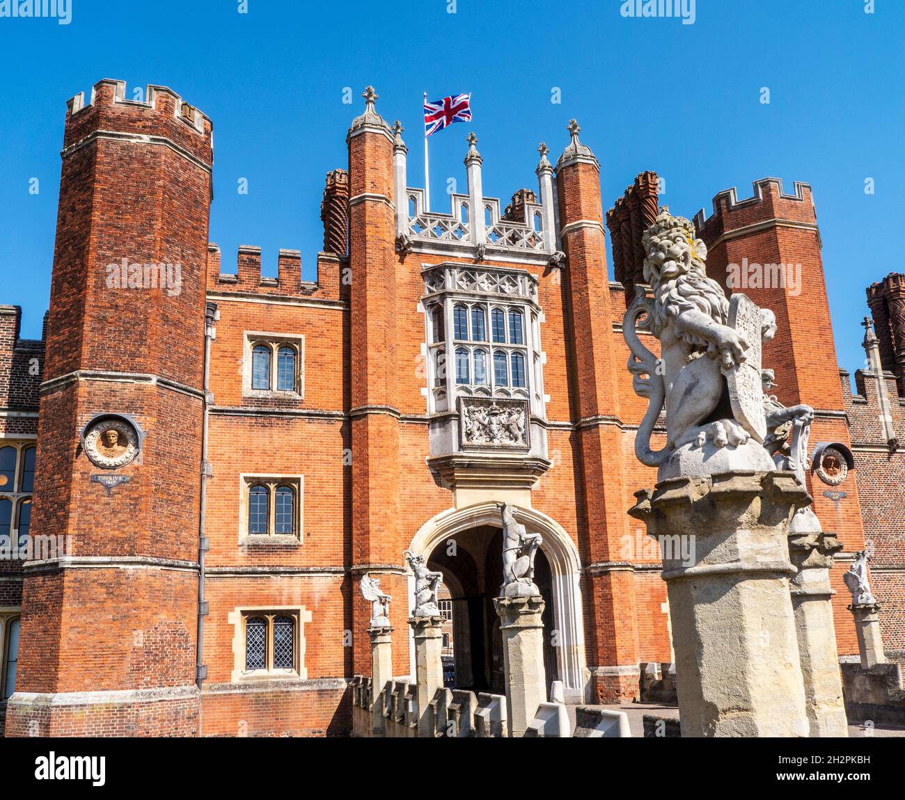 Hampton Court Palace entrance with Union Jack Flag flying, a royal Tudor palace in the London Borough of Richmond upon Thames Greater London Surrey UK Stock Photo