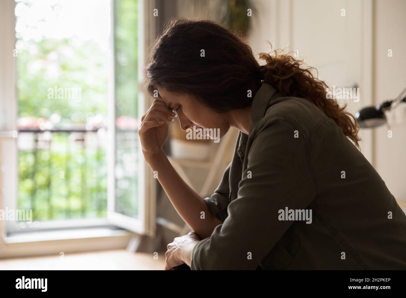 Worried frustrated young woman feeling depressed and lonely Stock Photo